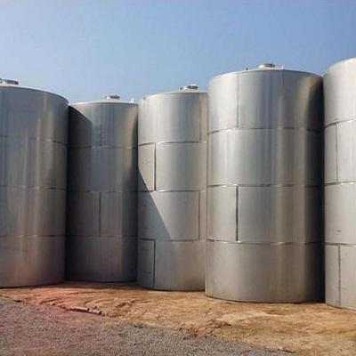 Row of food grade stainless steel tanks in a processing plant