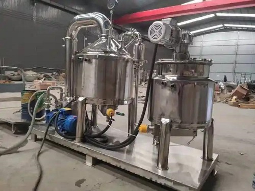 Commercial honey concentrator machine with stainless steel vacuum tank and control panel in a honey processing plant